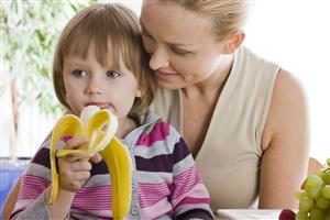 small girl eating banana