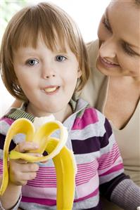 small girl eating banana