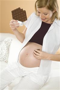 pregnant woman eating chocolate