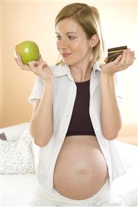 pregnant woman with apple and piece of cake