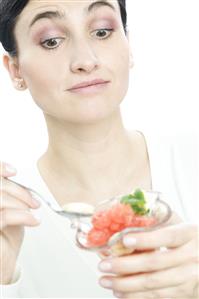 woman eating fruit salad