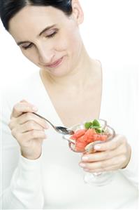 woman eating fruit salad