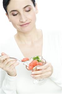 woman eating fruit salad