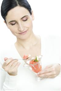 woman eating fruit salad