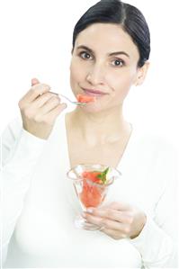 woman eating fruit salad