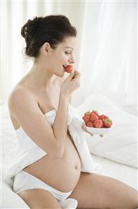 pregnant woman eating strawberries