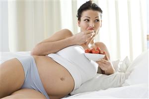 pregnant woman eating strawberries