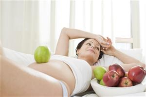 pregnant woman eating apples