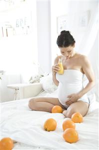 pregnant woman drinking orange juice