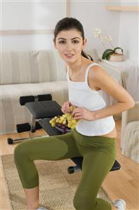 young woman eating grapes