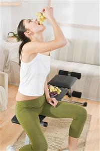 young woman eating grapes