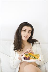 young woman eating fruit salad