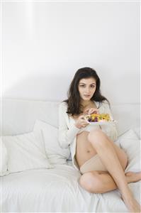 young woman eating fruit salad