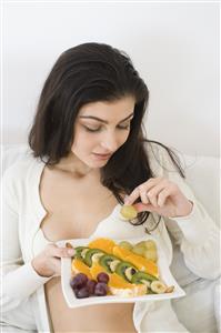 young woman eating fruit salad