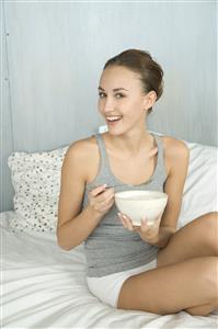 young woman eating muesli