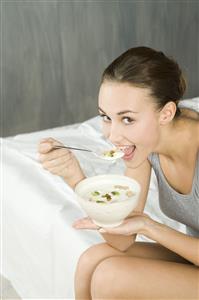 young woman eating muesli