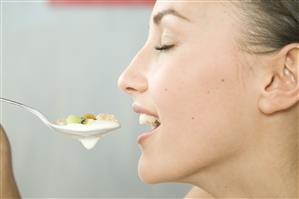 young woman eating muesli