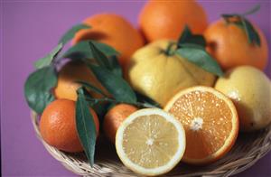 Naranjas, limones, mandarinas y pomelos en un cestito.