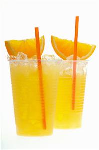 Orange juice with crushed ice, orange wedges and straw