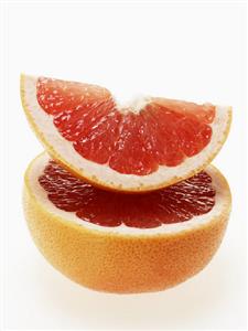 Wedge of pink grapefruit on grapefruit half