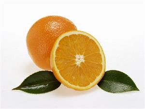 Whole and half orange with leaves and drops of water