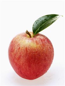 Red apple with stalk, leaf and drops of water