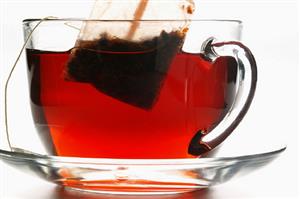 Hibiscus tea in glass cup with tea bag