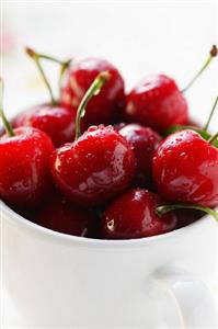 Fresh red cherries in beaker