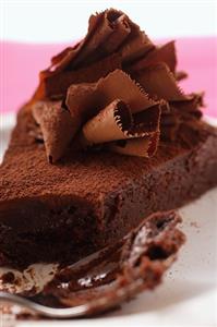 Piece of chocolate cake with chocolate curls