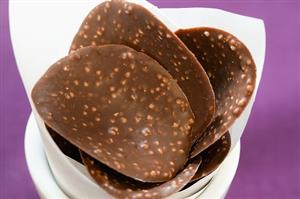 Chocolate curves with chopped nuts