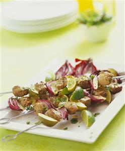 Lamb and onion kebabs with lime wedges