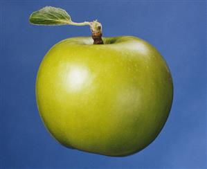 A green apple with leaf