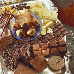 Still life with various types of chocolate & profiteroles