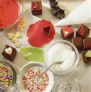 Baking still life with edible decorations & chocolate squares