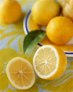 Lemons, several whole and one halved