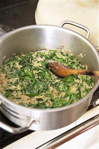 Making spinach soup: sweating the spinach with rice