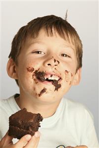 Boy eating a piece of chocolate cake