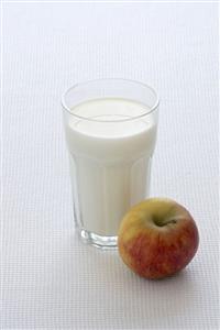 A glass of milk and an apple