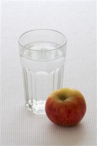 A glass of water and an apple