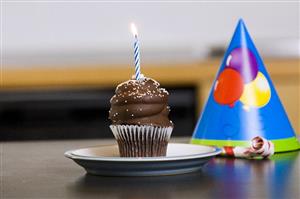 Chocolate cupcake with one candle