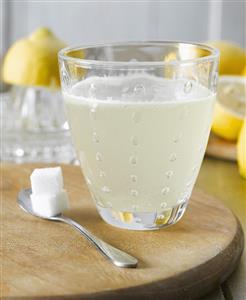 Hot lemon with sugar cubes, lemons in background