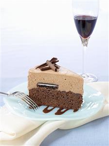 A piece of chocolate cake and a glass of red wine