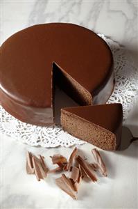 Sachertorte (Austrian chocolate cake) with a piece cut