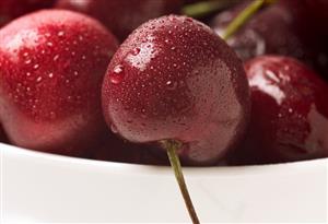 Cherries covered in condensation in a small bowl