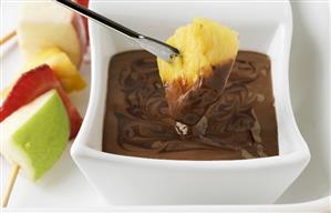 Chocolate fondue with skewered fruit