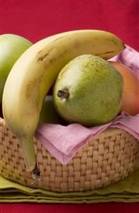 Pears, banana and grapefruit in fruit basket