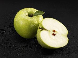 Whole and half 'Granny Smith' apple