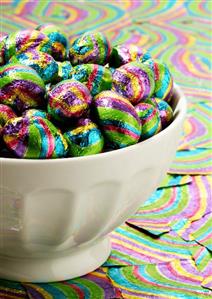 Coloured chocolate eggs in a bowl