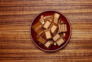 Pieces of chocolate on brown plate