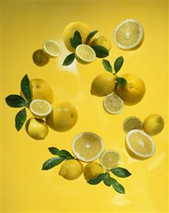 Whole and half lemons with leaves